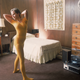 An unidentified young woman, dressed in a yellow leotard and matching tights, exercises in her wood-panelled room, to the music from a record player on the floor, 1980s. (Photo by Susan Wood/Getty Images)
